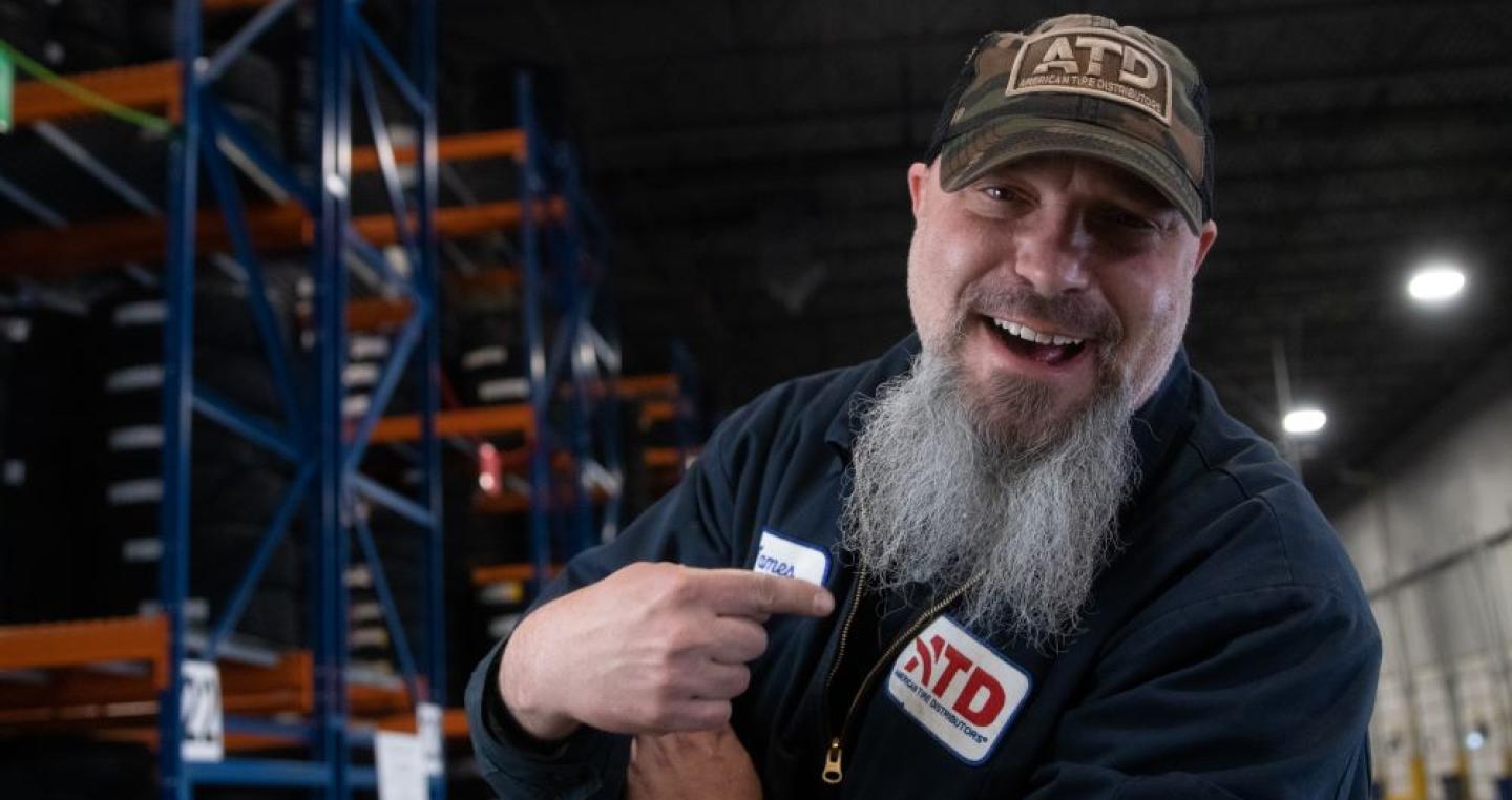 Male associate smiling with a long white/grey beard