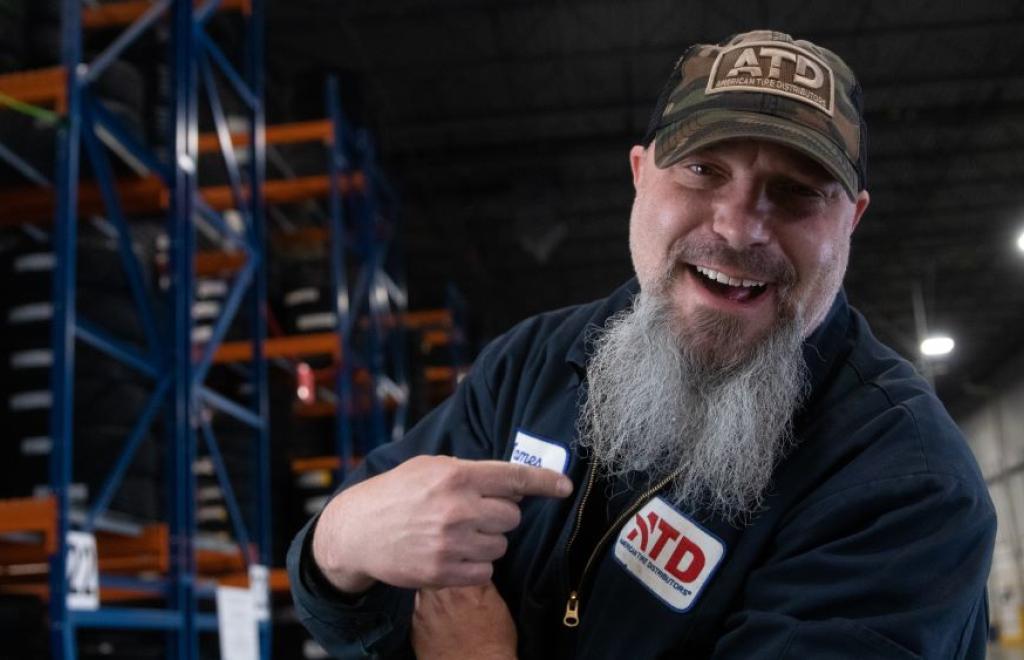 Male associate smiling with a long white/grey beard